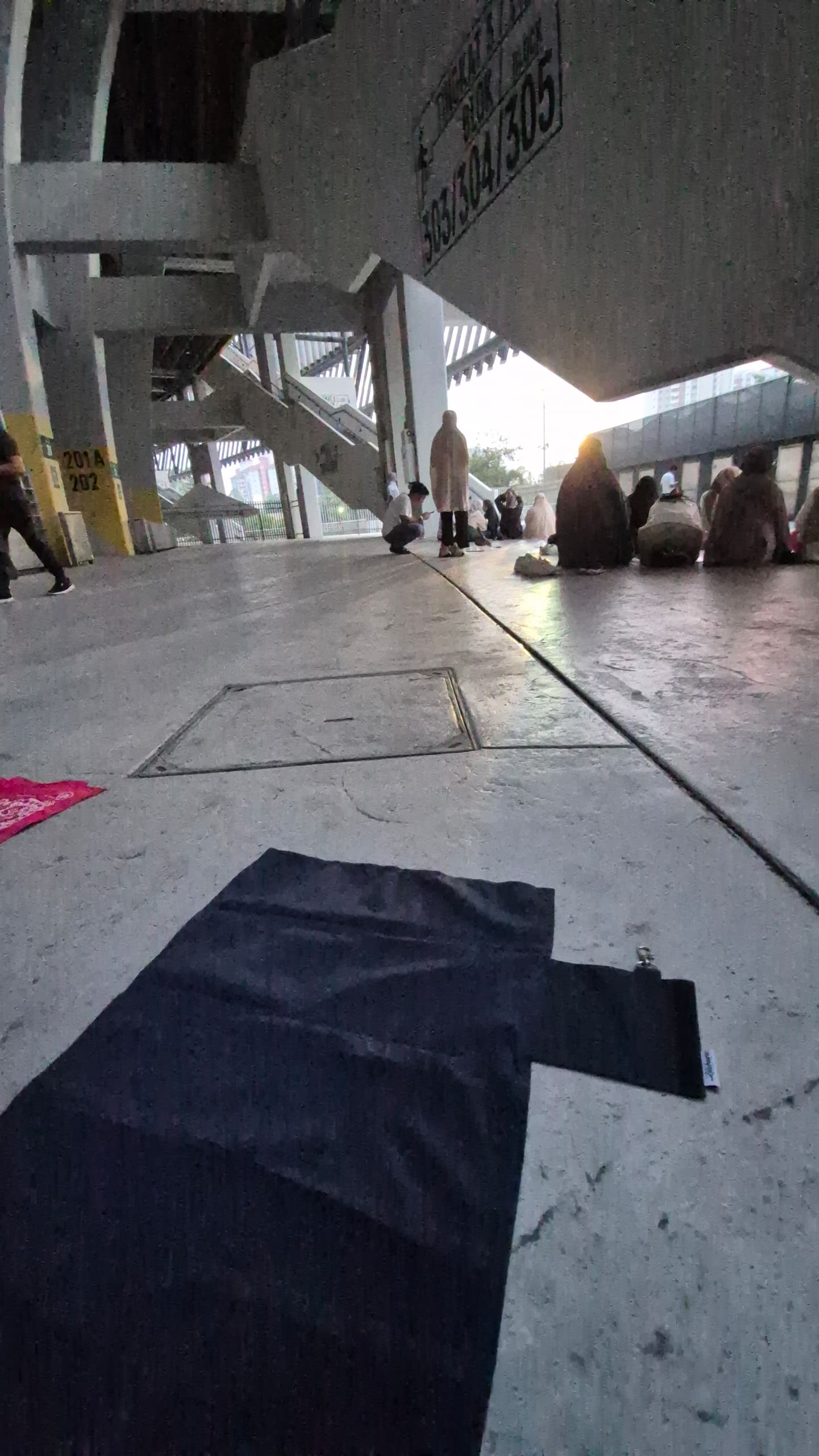 Zaahara instant roll-up prayer mat laid out at stadium as Muslims prepare for Maghrib prayer before a concert